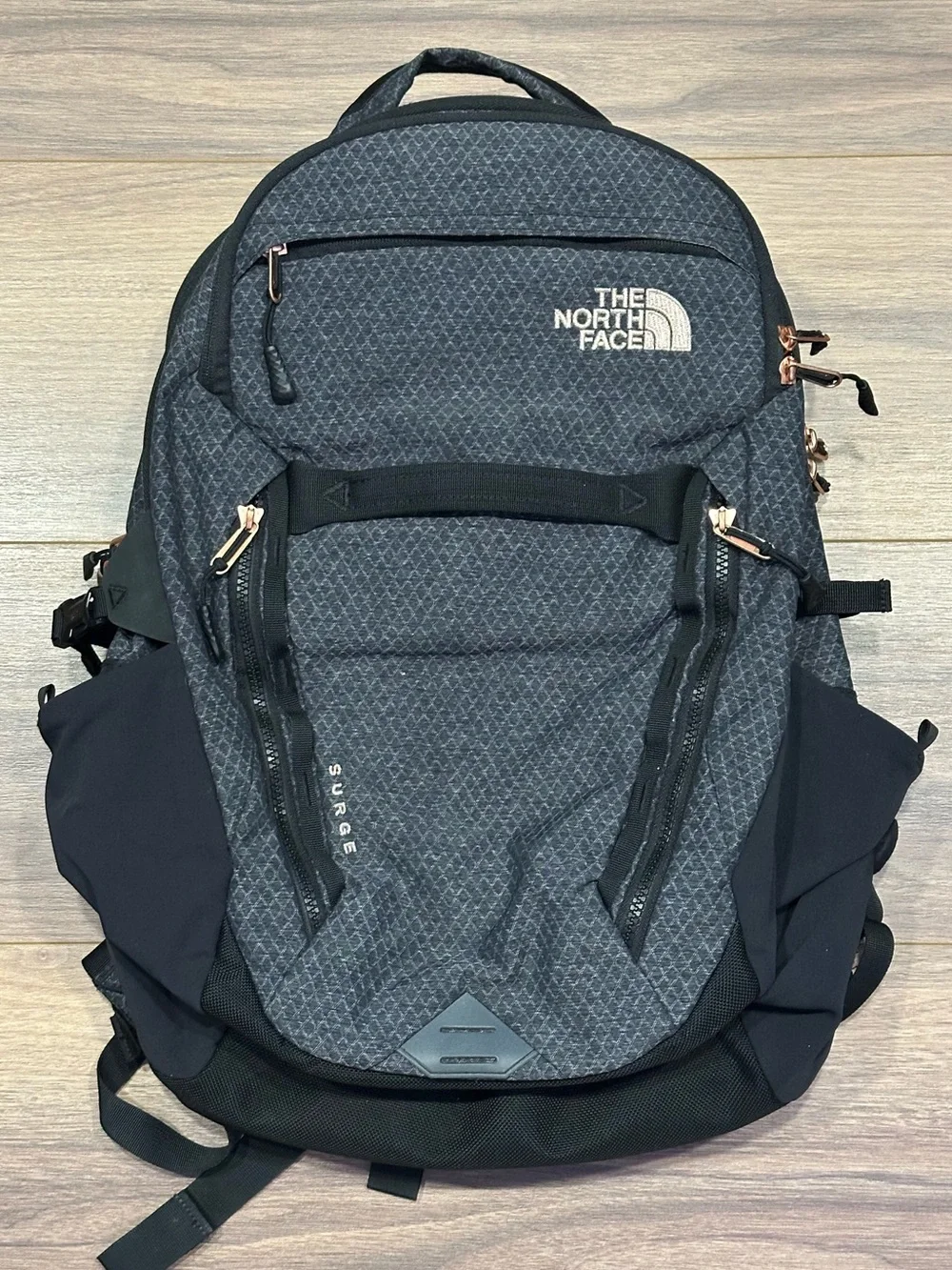 The North Face Surge Backpack in TNF Black Heather Copper/TNF Black